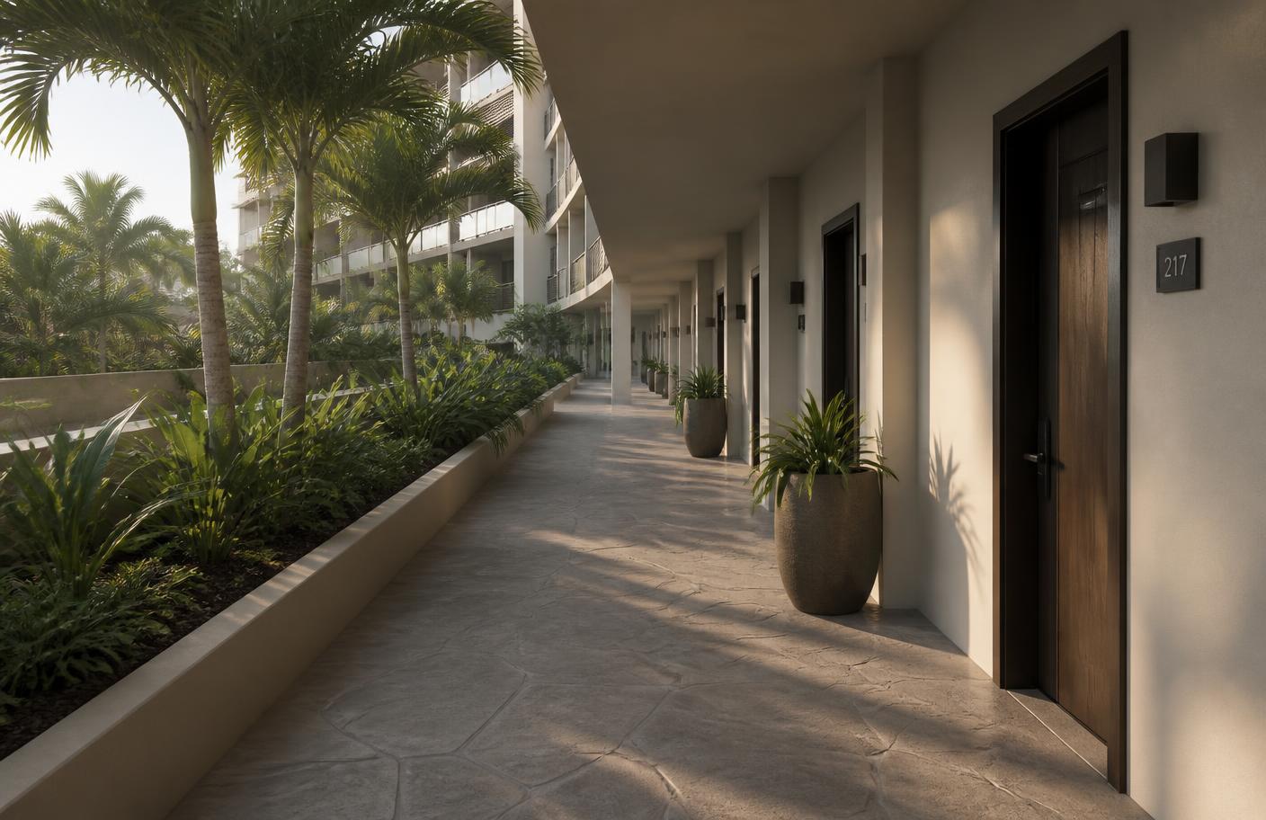 Exterior hotel walkway with textured paving and landscaping